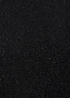 a close up of a Sarvin Black Cowl Back Gown with dots on it.