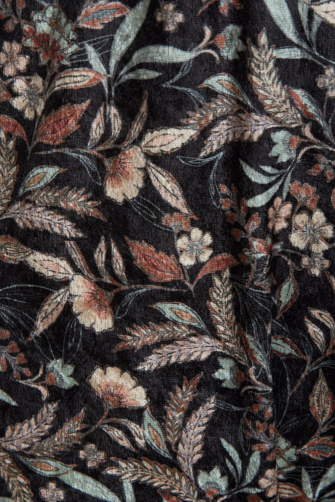 a close up of a Sarvin Floral Velvet Backless Jumpsuit with a floral pattern.
