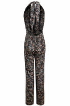 A Sarvin Floral Velvet Backless Jumpsuit on a white background.